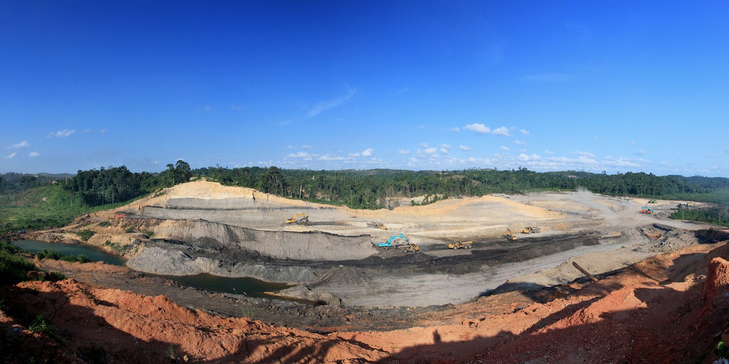 Image: a coal mining site in Indonesia, surrounded by forest. Creative commons. Image credit: Parolan Harahap